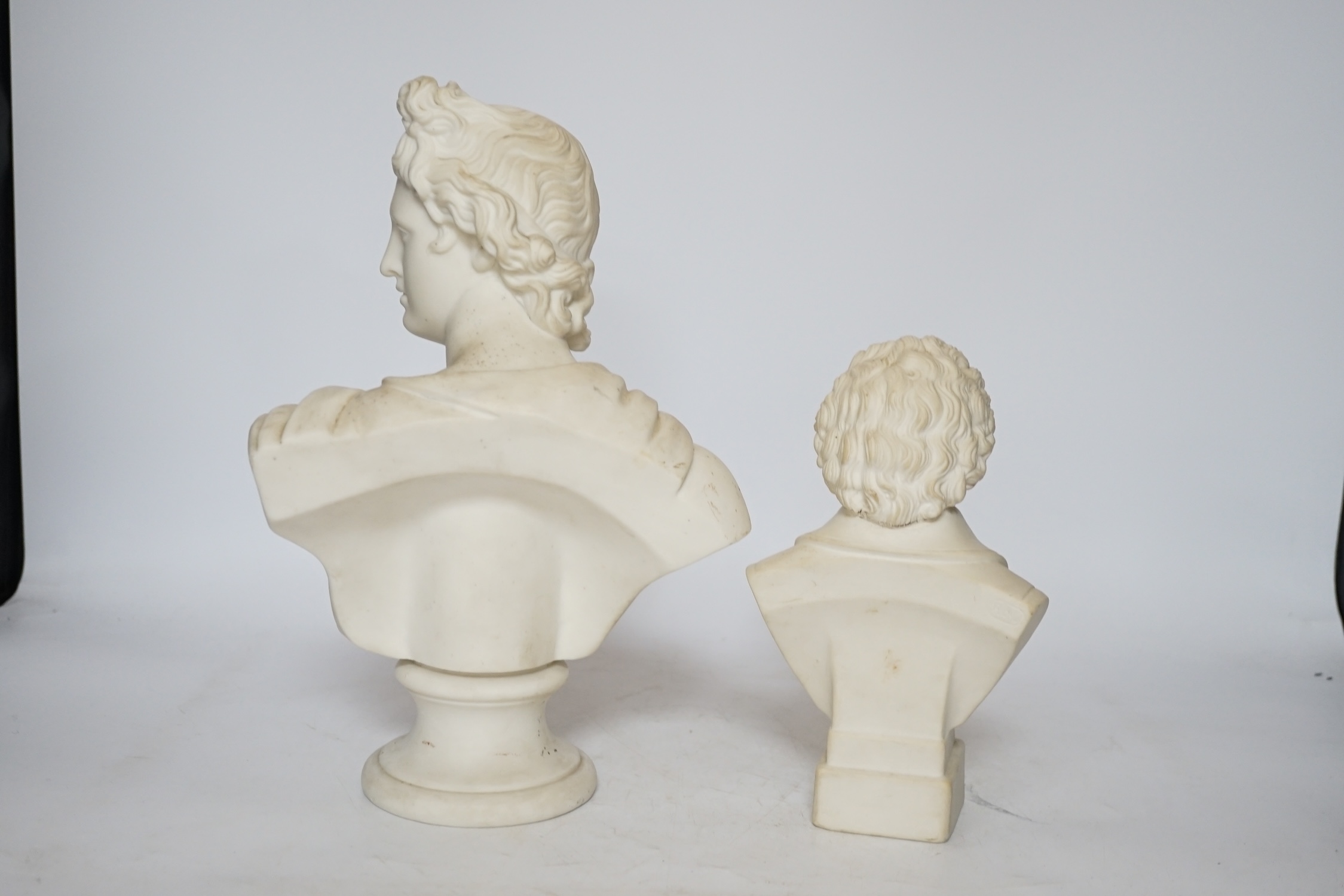 Two Continental biscuit porcelain busts, Mozart and Apollo, tallest 29cm
